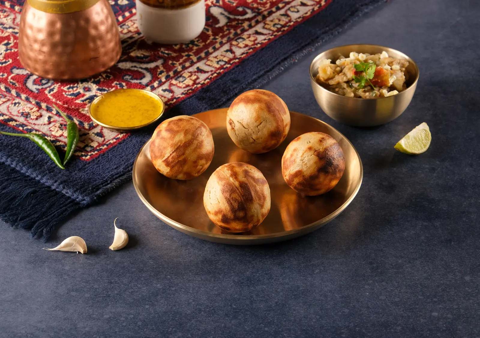 Slow-cooked OG litti on a brass plate